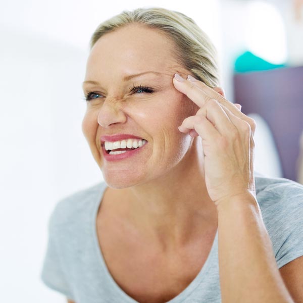 person with hand by face