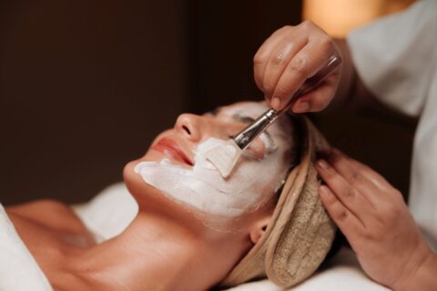 Esthetician Applying A Facial Mask Treatment To A Client